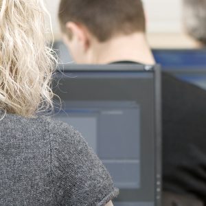Adults working in a computer classroom